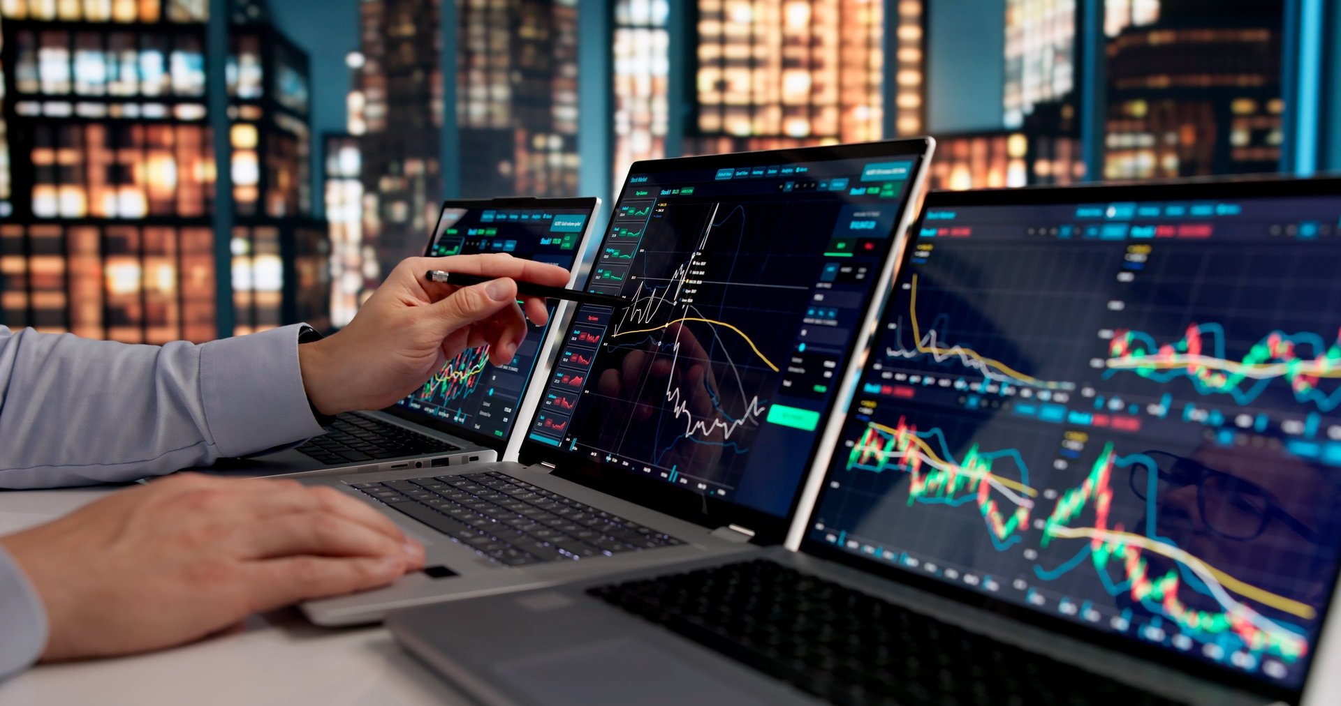 Stockbroker monitoring market trends on laptop